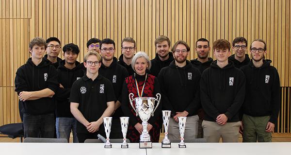 Photo of Edinburgh University Formula Student team standing with Jane Hillston behind trophy collection
