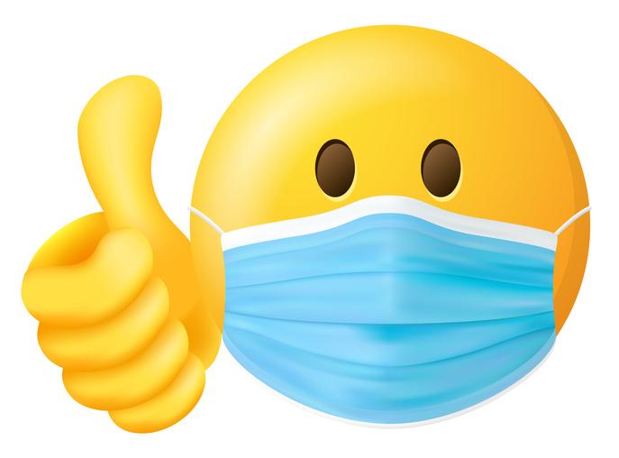 An emoji wearing a face mask with a thumb up