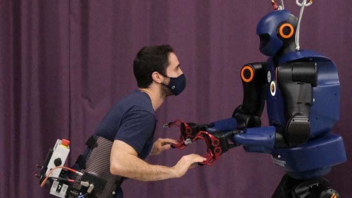 Triadic collaboration between human, robot, and exoskeleton 